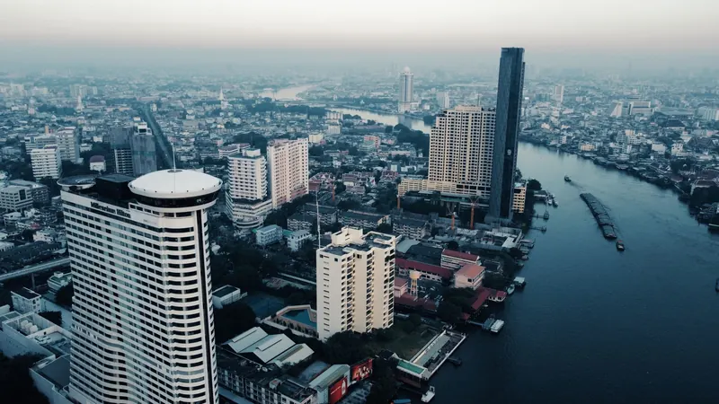 The Chao Phraya river turning through Bangkok, towers along both banks