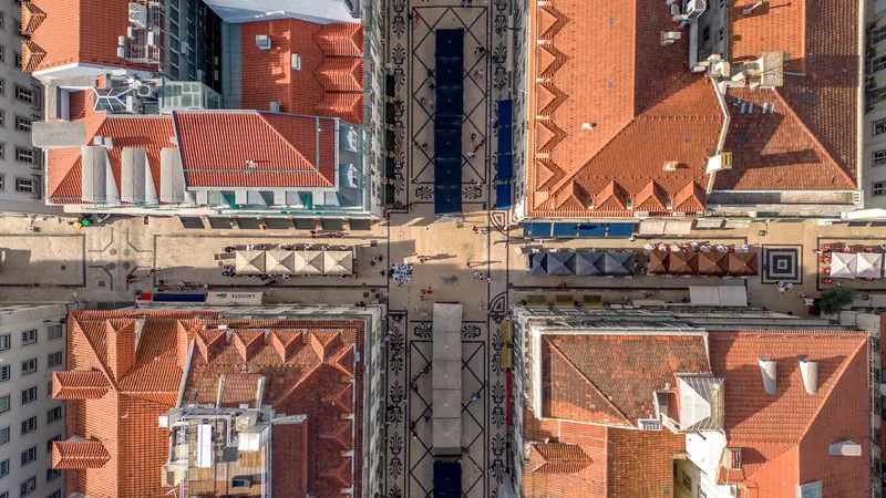 Terracotta rooftops and narrow streets across Lisbon's old town, seen from above