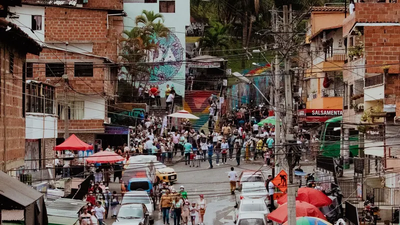 Houses climbing a Medellín hillside with the city filling the valley below